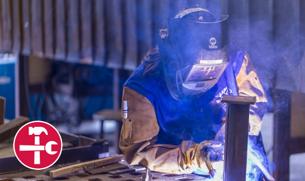  Welding student welding together metals  