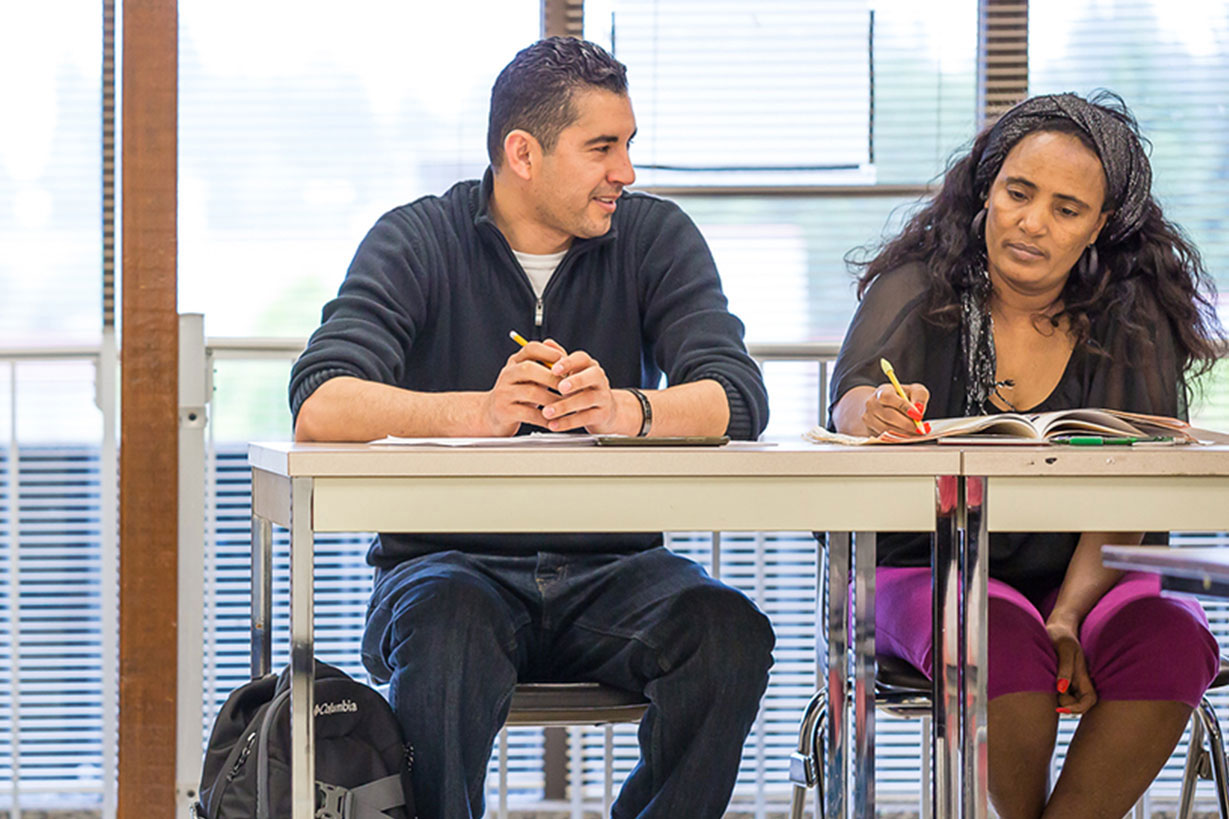 two students sit at table