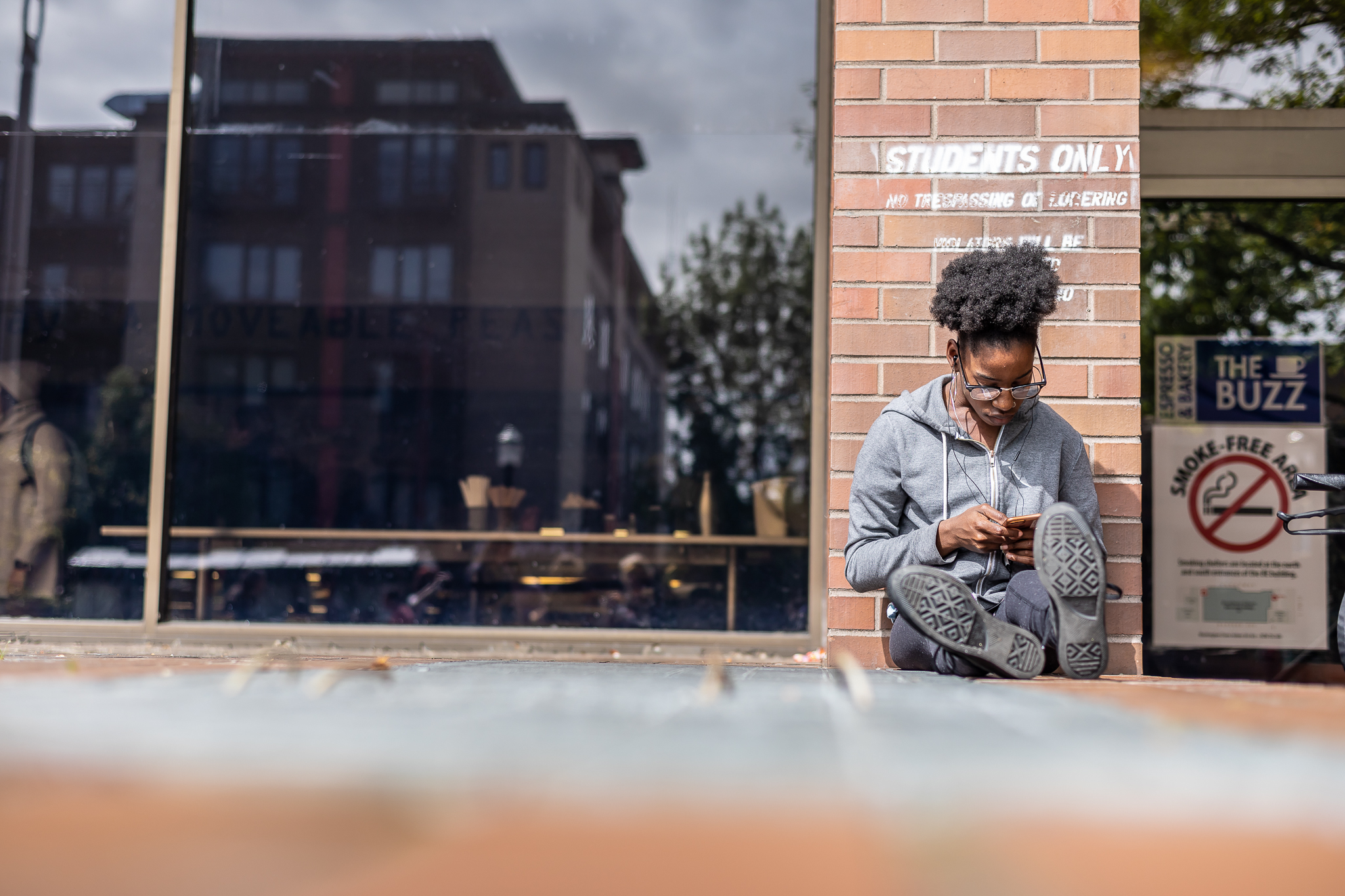 Student sitting next to the Buzz Cafe